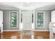 Bright foyer with hardwood floors, sidelight windows flanking the front door, and neutral paint color at 5304 W Oaks Dr, Fuquay Varina, NC 27526