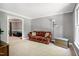 Spacious living room with a view to a connected living room and a large window at 5304 W Oaks Dr, Fuquay Varina, NC 27526