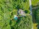 Aerial view of home, pool, and lush landscaping in a tranquil, wooded neighborhood at 5520 Creek Pine Dr, Wake Forest, NC 27587
