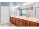 Bathroom with double sink vanity, large mirror and shower with blue walls and tile flooring at 5520 Creek Pine Dr, Wake Forest, NC 27587