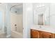 Well lit bathroom with light blue walls, shower and tub combo, light wood cabinets, and light countertops at 5520 Creek Pine Dr, Wake Forest, NC 27587