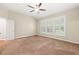 Bright bedroom with carpeting, a ceiling fan, and three large windows with plantation shutters at 5520 Creek Pine Dr, Wake Forest, NC 27587