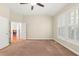 Neutral bedroom with a ceiling fan and natural light, featuring two windows at 5520 Creek Pine Dr, Wake Forest, NC 27587