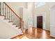 Grand foyer with hardwood floors, high ceilings, and a staircase with iron railings at 5520 Creek Pine Dr, Wake Forest, NC 27587