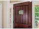 Close up of the decorative wooden front door with inset window at 5520 Creek Pine Dr, Wake Forest, NC 27587