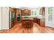 Updated kitchen features wood cabinets, granite counters, stainless appliances, and hardwood floors at 5520 Creek Pine Dr, Wake Forest, NC 27587