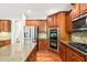 Gourmet kitchen boasts stainless steel appliances, granite countertops, and wood cabinets at 5520 Creek Pine Dr, Wake Forest, NC 27587