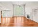 Open-concept living room with hardwood floors, vaulted ceiling, and a cozy fireplace at 5520 Creek Pine Dr, Wake Forest, NC 27587