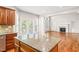 Open floor plan showcasing kitchen island looking into the living room with fireplace and built-ins at 5520 Creek Pine Dr, Wake Forest, NC 27587