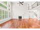 Bright living room with hardwood floors, fireplace, built-ins, large windows, and high ceilings at 5520 Creek Pine Dr, Wake Forest, NC 27587