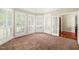 Sun-filled living area with large windows, shutters, and neutral carpeting at 5520 Creek Pine Dr, Wake Forest, NC 27587