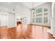 Spacious living room with hardwood floors, large windows, and an open floor plan at 5520 Creek Pine Dr, Wake Forest, NC 27587