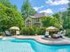 Inviting backyard pool area with lounge chairs and umbrellas, set against lush landscaping and home exterior at 5520 Creek Pine Dr, Wake Forest, NC 27587