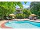 Backyard pool area, showcasing lounge chairs, umbrellas, and lush, private landscaping at 5520 Creek Pine Dr, Wake Forest, NC 27587
