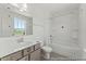 Bathroom with ample natural light, features a tub and a sleek single sink vanity at 56 Mable Court # 20, Lillington, NC 27546