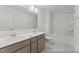 Bright bathroom featuring double sink vanity, large mirror, and shower-tub combination at 56 Mable Court # 20, Lillington, NC 27546