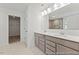 Bathroom with double vanity, large mirror, and view into walk in closet at 56 Mable Court # 20, Lillington, NC 27546