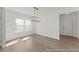 Inviting dining area bathed in natural light, featuring stylish lighting and wood flooring at 56 Mable Court # 20, Lillington, NC 27546
