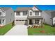 Charming two-story home featuring a two-car garage, covered porch, and beautifully landscaped front yard at 56 Mable Court # 20, Lillington, NC 27546
