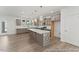 Bright kitchen with a generous island, stainless steel appliances, and convenient access to the outdoors at 56 Mable Court # 20, Lillington, NC 27546