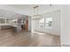 Open-concept living area with hardwood floors and natural light flowing from adjacent kitchen and windows at 56 Mable Court # 20, Lillington, NC 27546