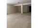 Large, open basement area with neutral carpeting and support beams at 5804 Claribel Ct, Raleigh, NC 27612