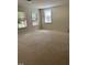 Spacious bonus room with three windows providing natural light and comfortable carpeting at 5804 Claribel Ct, Raleigh, NC 27612