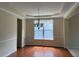 Dining room features hardwood floors, a tray ceiling, and a window with natural light at 5804 Claribel Ct, Raleigh, NC 27612