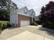 Two-story home boasts a brick and siding exterior with a spacious driveway leading to an attached garage at 5804 Claribel Ct, Raleigh, NC 27612