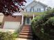 Traditional home featuring a brick facade, light blue siding, and a welcoming front porch at 5804 Claribel Ct, Raleigh, NC 27612