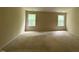 Large main bedroom with neutral carpeting and natural light from two windows at 5804 Claribel Ct, Raleigh, NC 27612