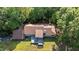 Aerial view of house surrounded by lush trees, showcasing the roof and large deck at 5900 Ebenezer Church Rd, Raleigh, NC 27612