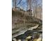 Charming house situated on a sloping hill near a creek, surrounded by trees at 5900 Ebenezer Church Rd, Raleigh, NC 27612