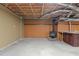 Spacious unfinished basement with exposed ceiling, a wood burning stove, and utility sink at 5900 Ebenezer Church Rd, Raleigh, NC 27612