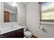 Updated bathroom features vanity, toilet, shower and blinds at 5900 Ebenezer Church Rd, Raleigh, NC 27612