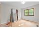 Empty bedroom with a large window and a closet at 5900 Ebenezer Church Rd, Raleigh, NC 27612