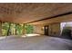 Spacious carport area offering covered parking and additional storage, with stairs leading to a door at 5900 Ebenezer Church Rd, Raleigh, NC 27612