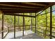 Exterior view of a wooden deck surrounded by green trees at 5900 Ebenezer Church Rd, Raleigh, NC 27612