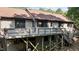 Exterior shot of a multi-level home featuring a large weathered wood deck and wood siding at 5900 Ebenezer Church Rd, Raleigh, NC 27612