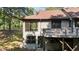 Back of house with a wooden deck and wooded view at 5900 Ebenezer Church Rd, Raleigh, NC 27612