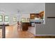 Expansive living area flows into the kitchen, enhanced by natural light and hardwood floors at 5900 Ebenezer Church Rd, Raleigh, NC 27612