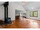 Spacious living room with wood-burning stove and hardwood floors at 5900 Ebenezer Church Rd, Raleigh, NC 27612