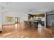Spacious living room features a kitchen and bar area, complemented by warm hardwood floors at 5900 Ebenezer Church Rd, Raleigh, NC 27612