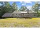 The back of the home shows an elevated deck, back yard, and lots of privacy at 5900 Ebenezer Church Rd, Raleigh, NC 27612