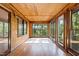 Sun room featuring wood paneled walls and ceiling with beautiful view at 5900 Ebenezer Church Rd, Raleigh, NC 27612
