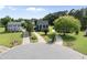 Overhead view of a charming home with a long driveway, surrounded by lush green lawns and mature trees at 6 W Canterbury Ct, Wendell, NC 27591