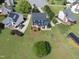 Aerial view of a property showcasing a large backyard, mature trees, and well-manicured landscaping at 6 W Canterbury Ct, Wendell, NC 27591