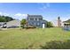 Expansive backyard featuring a deck, lush green lawn, and mature landscaping for outdoor enjoyment at 6 W Canterbury Ct, Wendell, NC 27591