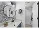 Well-lit bathroom with a single sink, decorative mirror, and walk-in shower at 6 W Canterbury Ct, Wendell, NC 27591