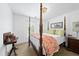 Cozy bedroom featuring a four-poster bed, complemented by a sunlit window and decorative elements at 6 W Canterbury Ct, Wendell, NC 27591